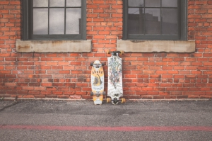 8563c-Canva---Two-White-and-Brown-Longboard-Leaning-on-Brown-Bricks-Wall.jpg
